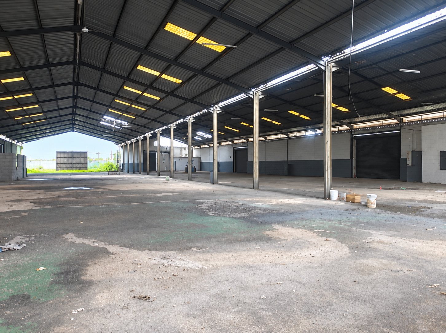 Clear-span steel-framed warehouse interior with roller-shutter doors